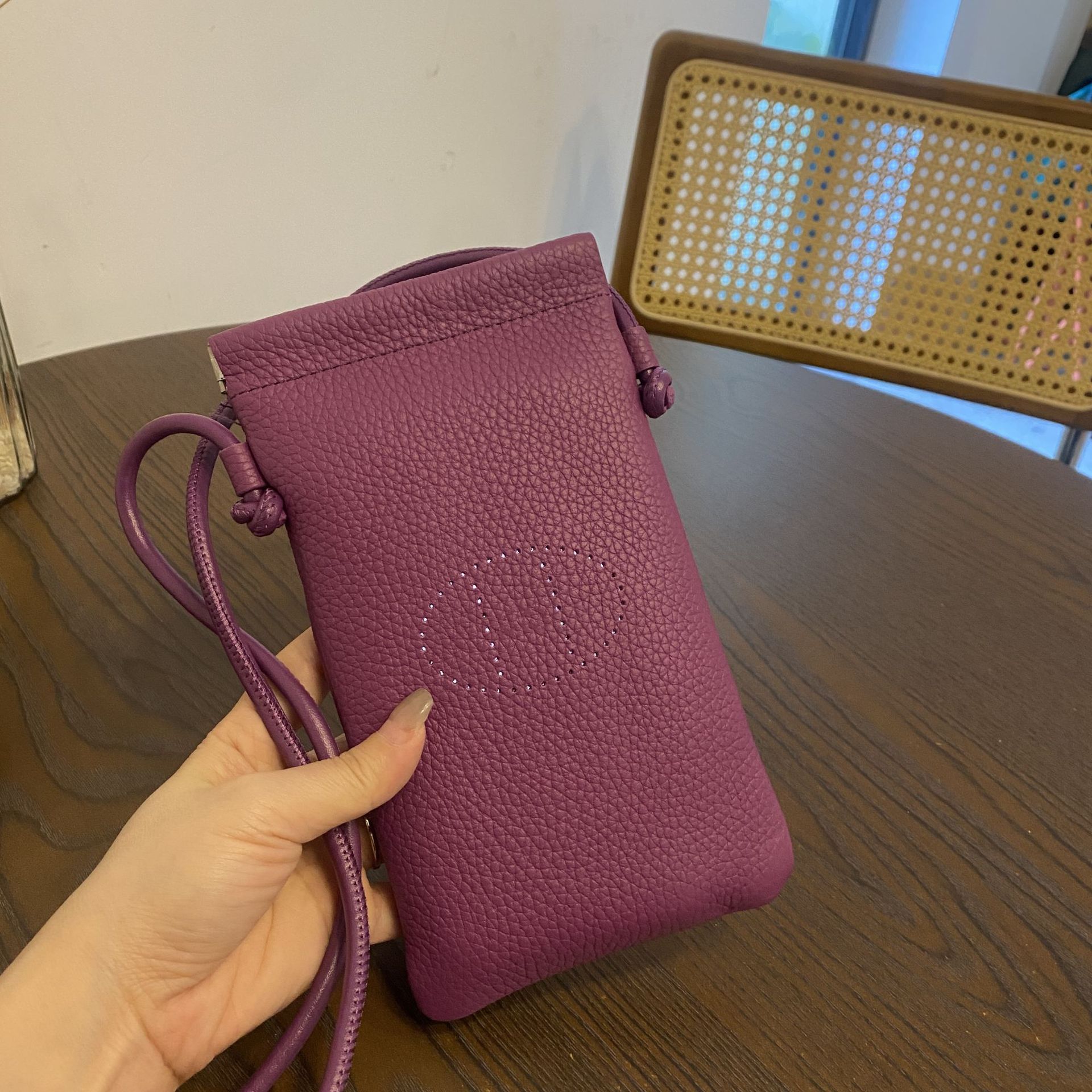 Picture of New first layer cowhide vertical mobile phone bag fashion simple shoulder messenger bag hollow soft leather drawstring small square bag