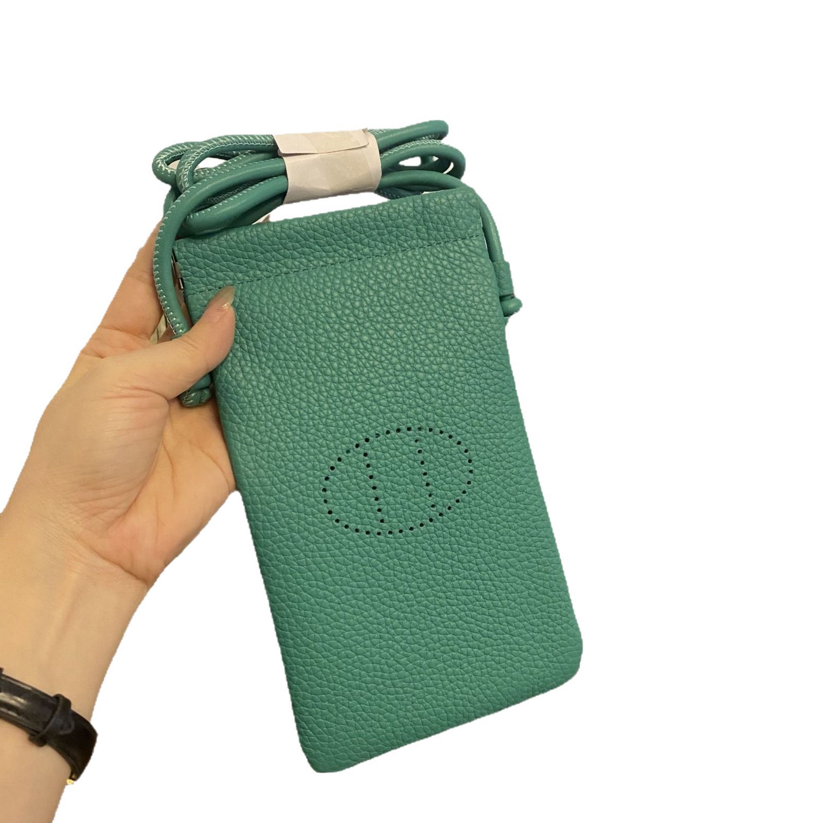 Picture of New first layer cowhide vertical mobile phone bag fashion simple shoulder messenger bag hollow soft leather drawstring small square bag