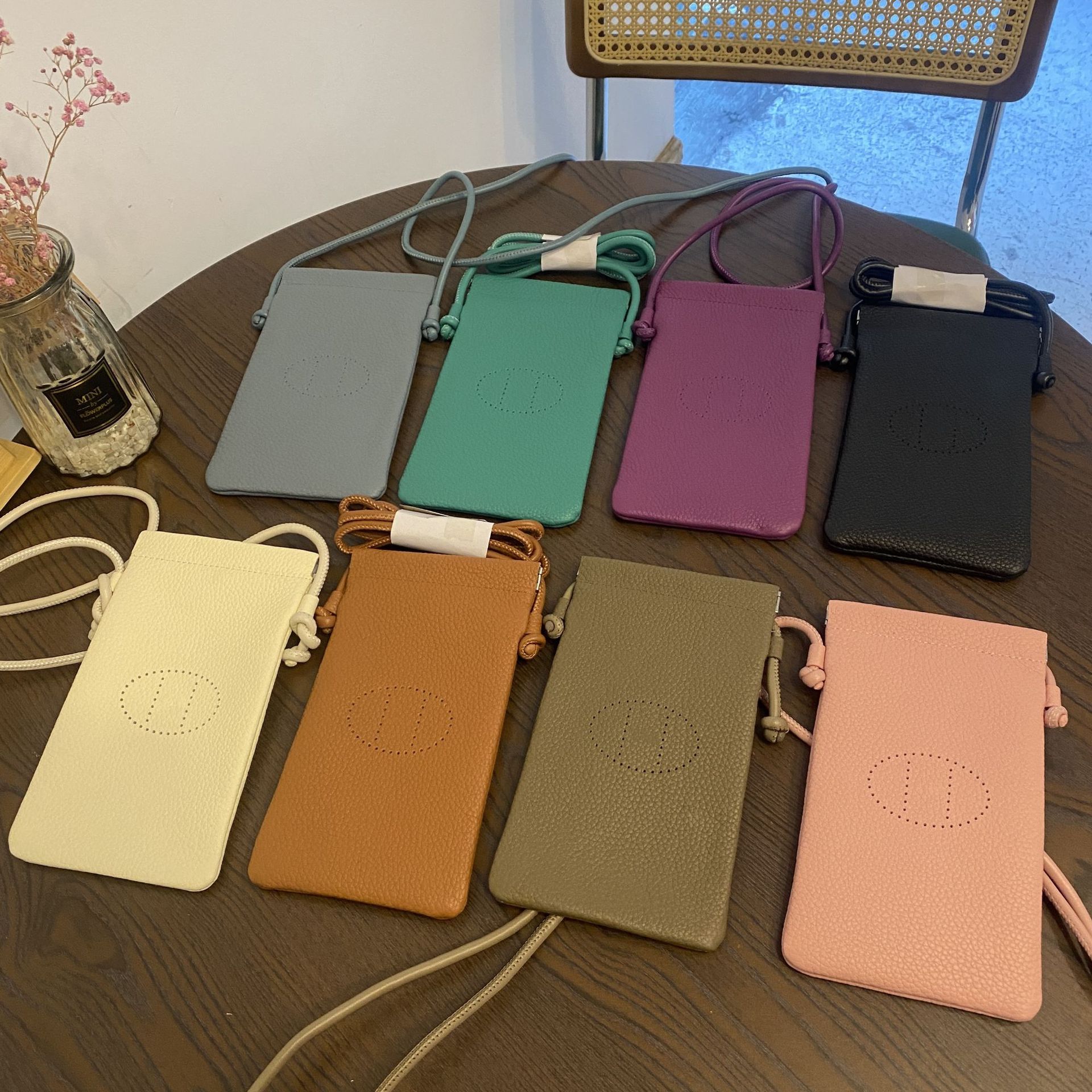 Picture of New first layer cowhide vertical mobile phone bag fashion simple shoulder messenger bag hollow soft leather drawstring small square bag